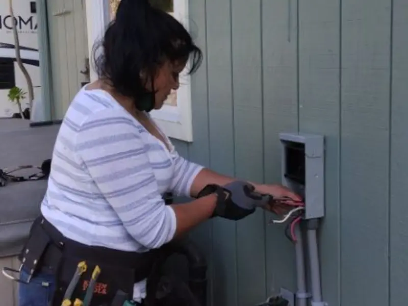 Licensed electrician wiring an exterior subpanel in Scissors